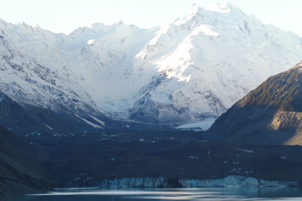 Snow-capped Aoraki / Mt Cook under clear blue sky, New Zealand’s tallest mountain.